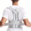 Correcteur de posture blanc cassé porté de dos pendant le réglage de la ceinture.